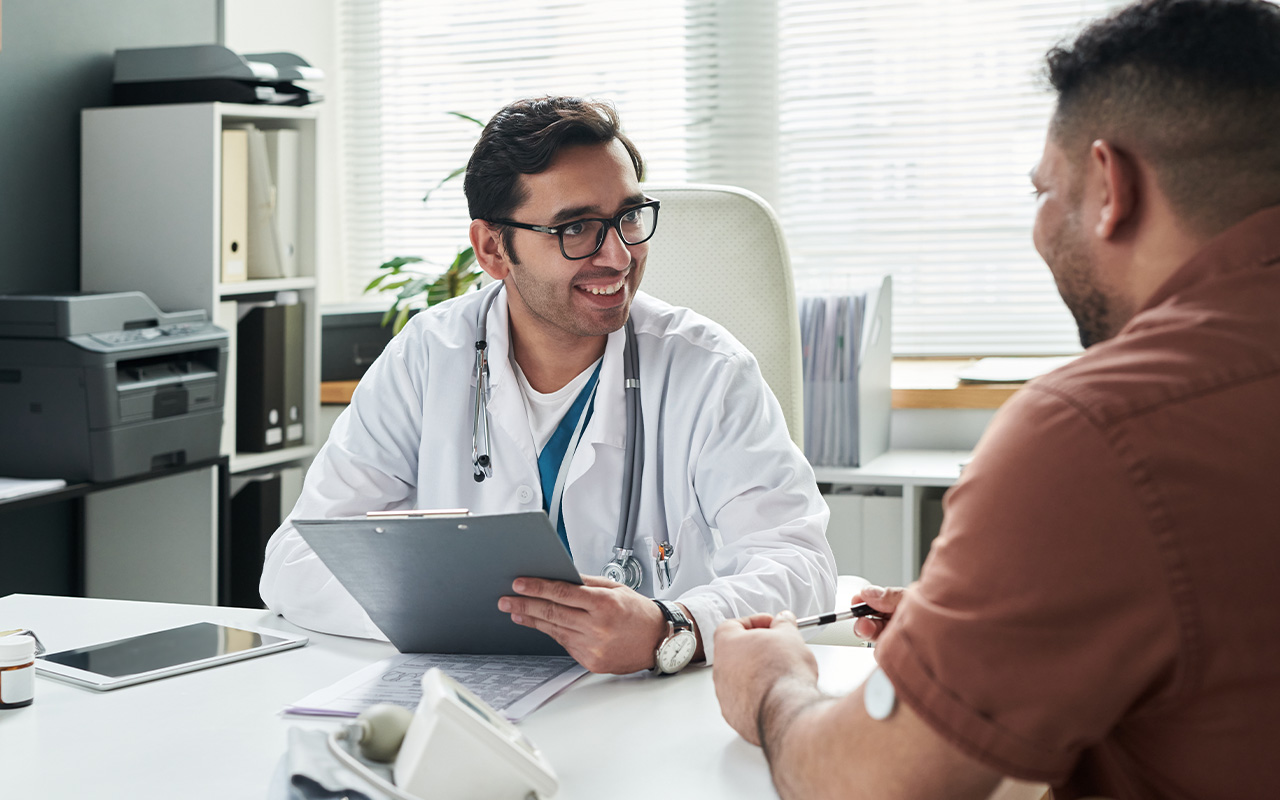 A provider sitting with a patient