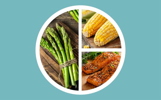 A plate with servings of asparagus, corn, and salmon.